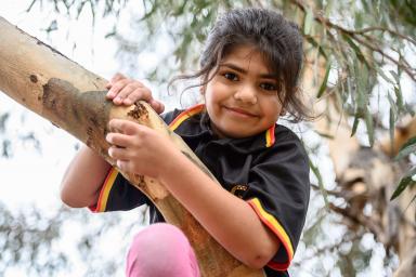 A young student playing in nature