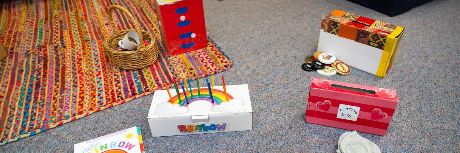 Children decorating a cardboard box