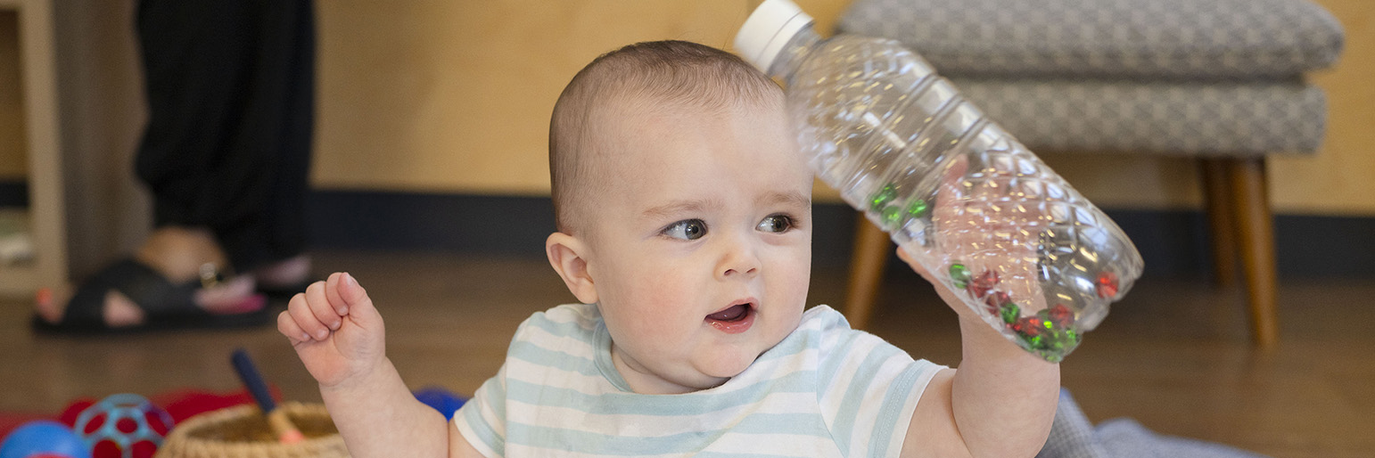 A child playing with discovery bottles