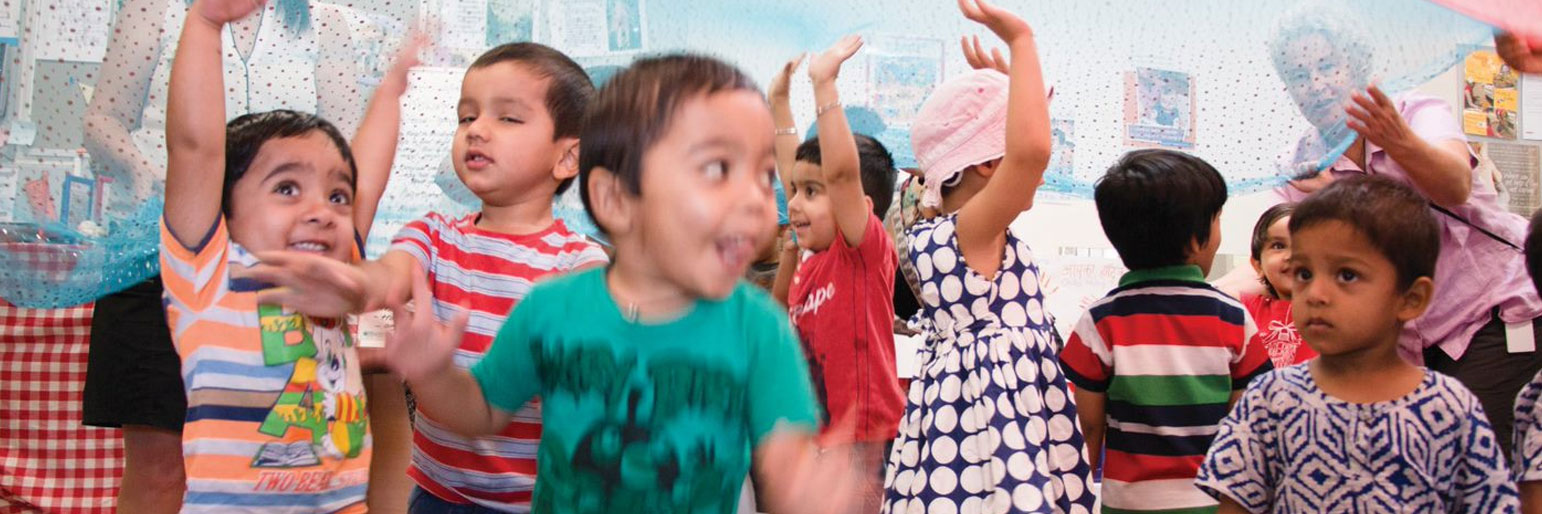 group of sitting children waving their arms