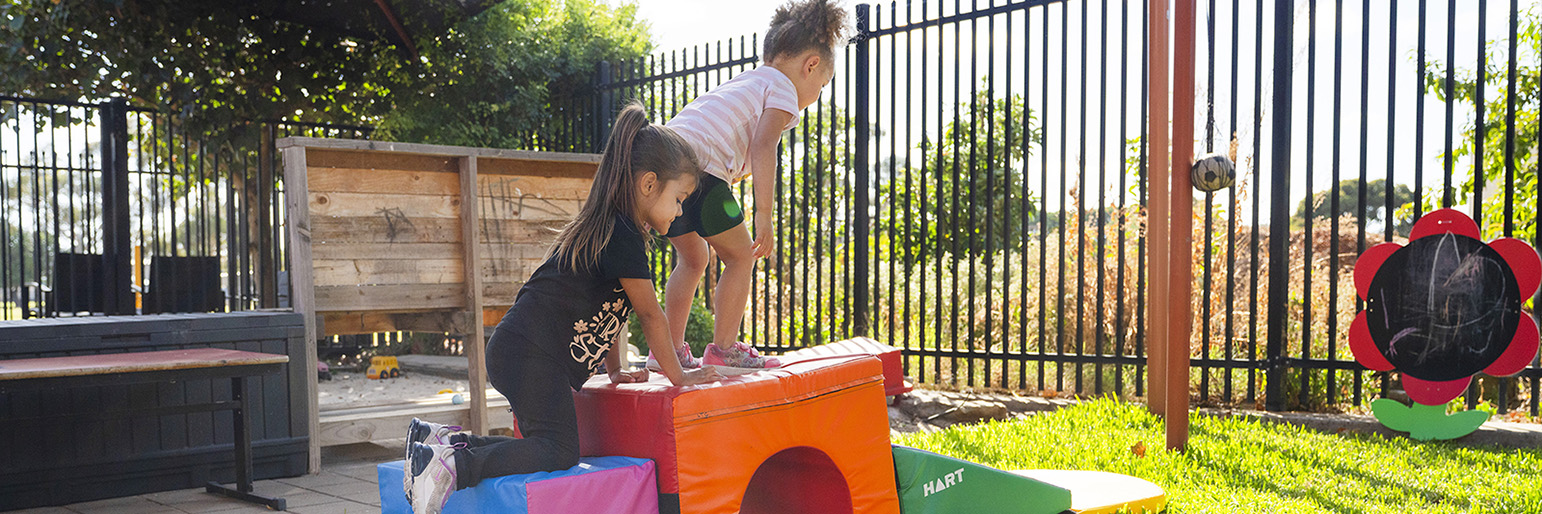 Parents helping their children play on an obstacle course