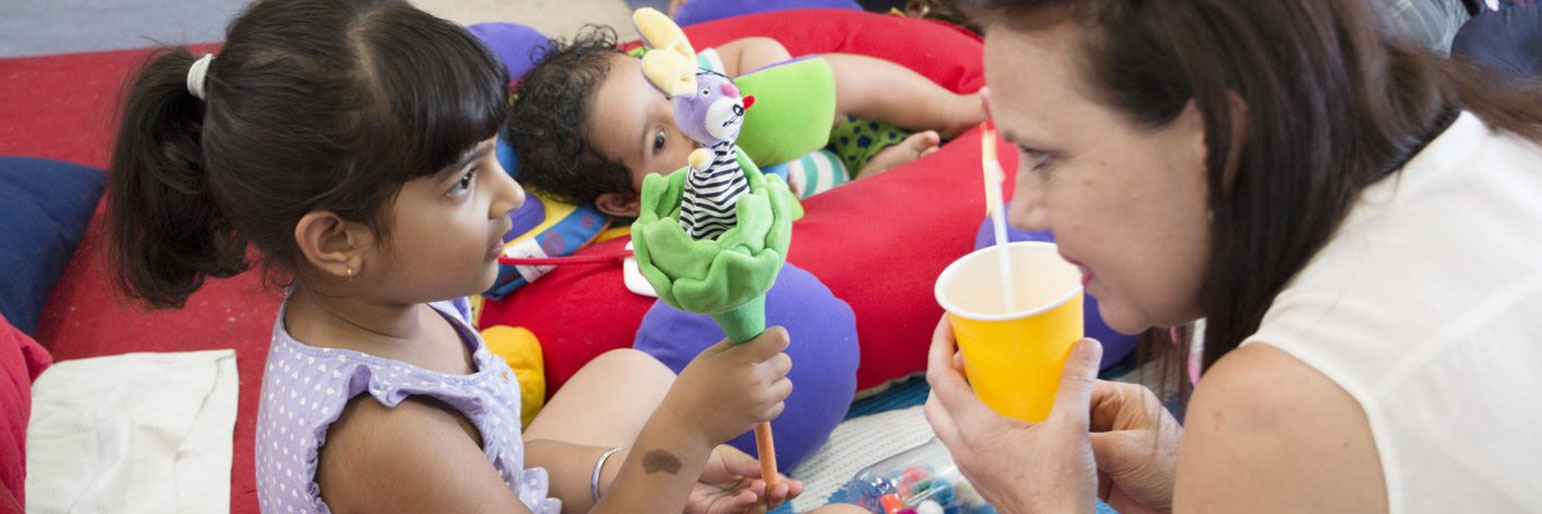 A child showing their mother a pop up puppet